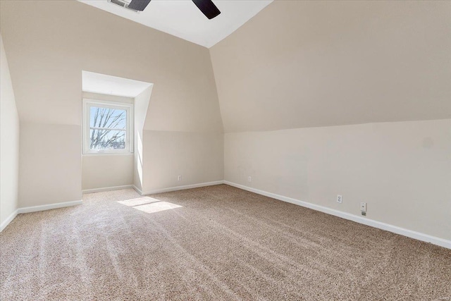 bonus room featuring ceiling fan, carpet, baseboards, and vaulted ceiling