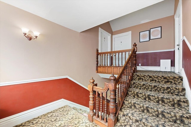 stairs with lofted ceiling and baseboards