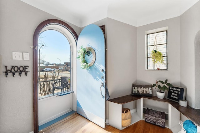 doorway to outside with wood finished floors and baseboards