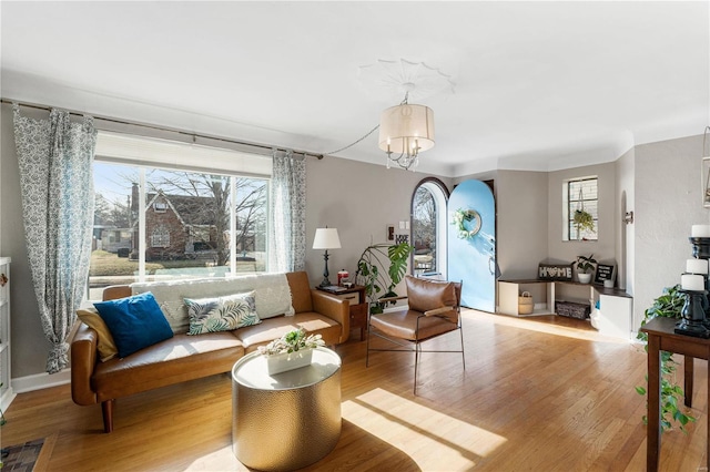 sitting room with a chandelier and wood finished floors