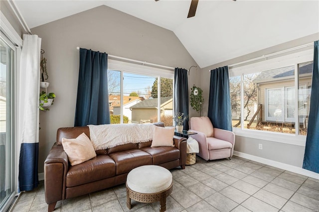 living area featuring ceiling fan, baseboards, and lofted ceiling