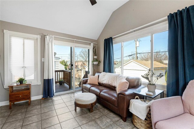 living room featuring light tile patterned floors, baseboards, and vaulted ceiling