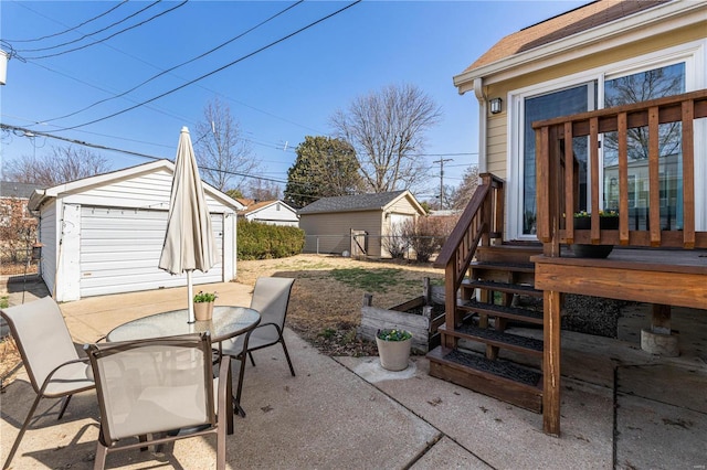 view of patio featuring an outbuilding and outdoor dining space