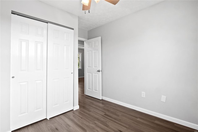 unfurnished bedroom with ceiling fan, wood-type flooring, a closet, and a textured ceiling