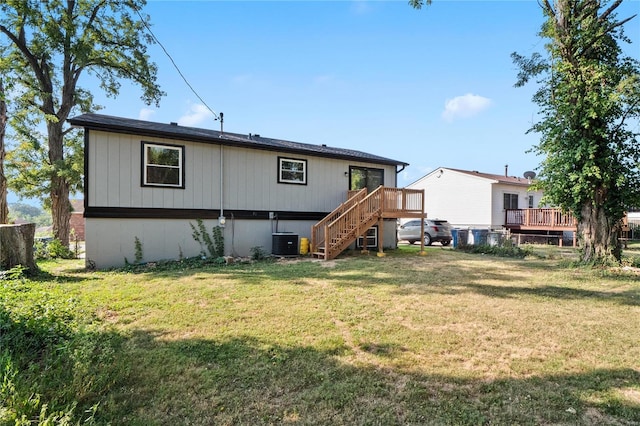 back of house featuring a wooden deck, a yard, and cooling unit