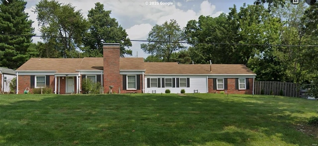 ranch-style home with brick siding, a chimney, fence, and a front yard