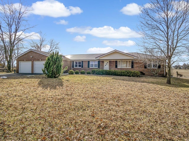 ranch-style house featuring a garage, a front lawn, aphalt driveway, and brick siding