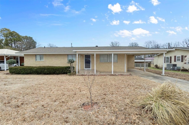 ranch-style house featuring cooling unit and a carport