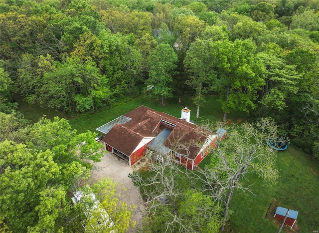 view from above of property with a heavily wooded area