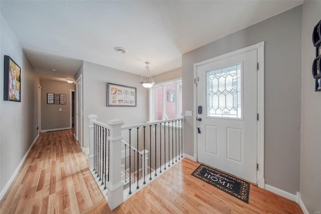 entrance foyer featuring wood finished floors and baseboards