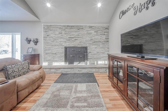 living area featuring lofted ceiling and wood finished floors