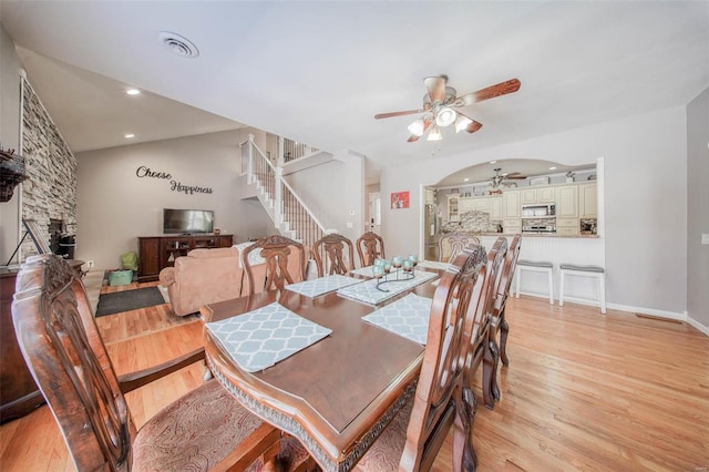 dining space with a ceiling fan, light wood-type flooring, stairway, recessed lighting, and baseboards