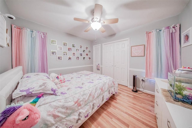 bedroom featuring a closet, light wood-style floors, a ceiling fan, and baseboards