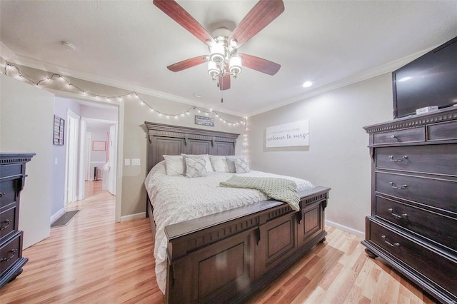 bedroom with light wood-type flooring, ornamental molding, baseboards, and ceiling fan