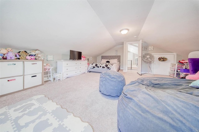 bedroom with vaulted ceiling and light colored carpet