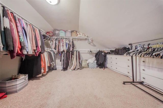 spacious closet with carpet floors and lofted ceiling