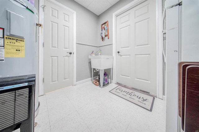 laundry area featuring baseboards