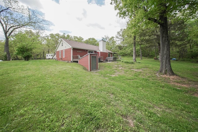 view of green lawn featuring a deck