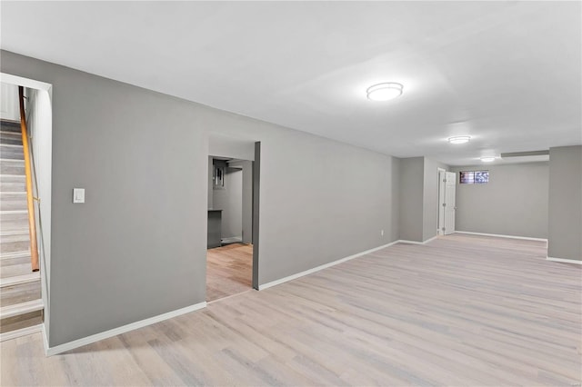 basement with light hardwood / wood-style flooring