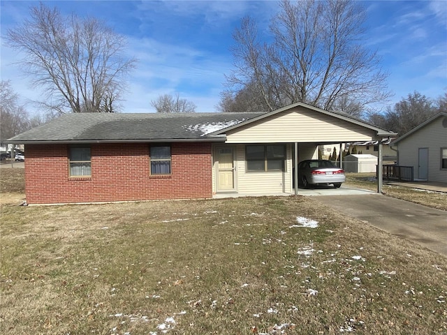 view of front facade with a carport, brick siding, a front lawn, and concrete driveway