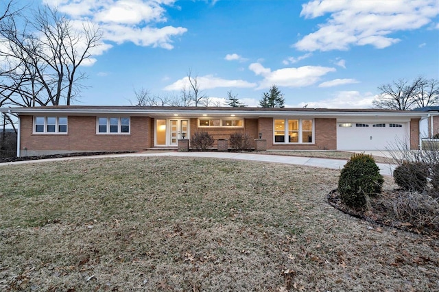 ranch-style home featuring a garage and a front lawn