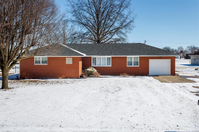 view of front facade with brick siding, an attached garage, and a shingled roof