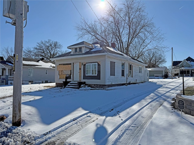 view of front of home featuring a residential view, a chimney, and central air condition unit