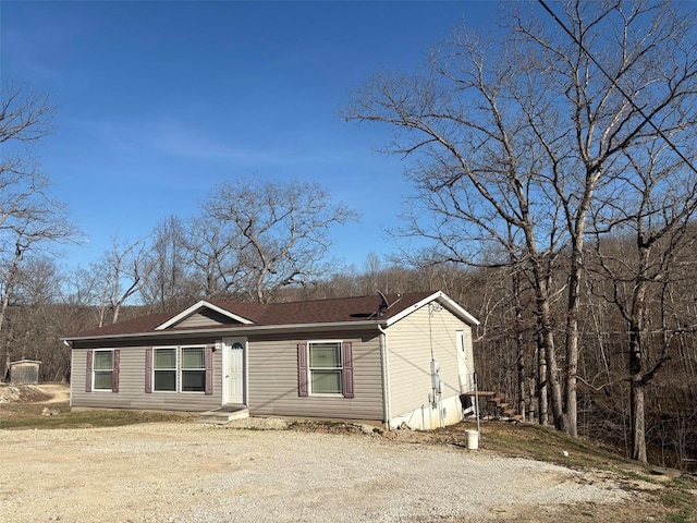 view of front of property with dirt driveway