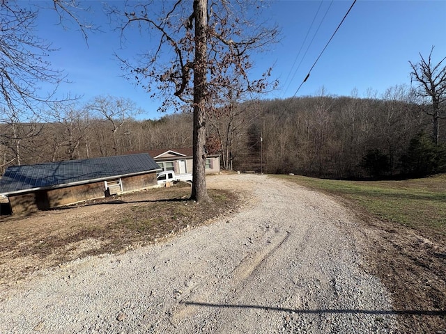 view of street featuring a forest view