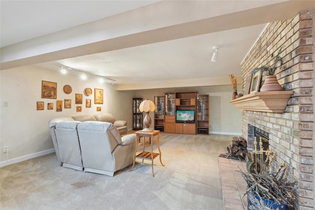 living room with rail lighting, light colored carpet, and a fireplace