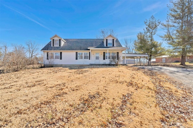 view of front of home with a carport, covered porch, and driveway