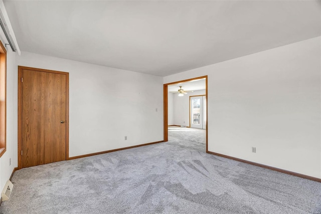 interior space with light colored carpet, visible vents, and baseboards