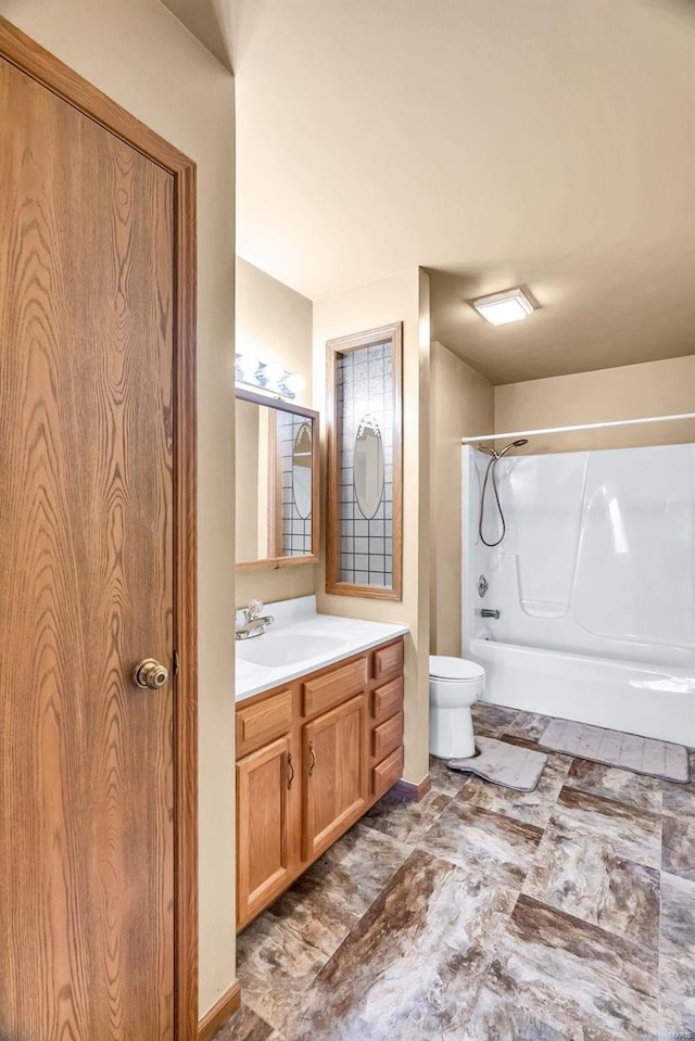 bathroom with toilet, shower / tub combination, and vanity