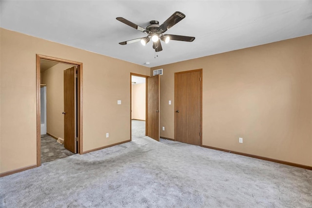 unfurnished bedroom featuring a ceiling fan, baseboards, visible vents, and carpet flooring