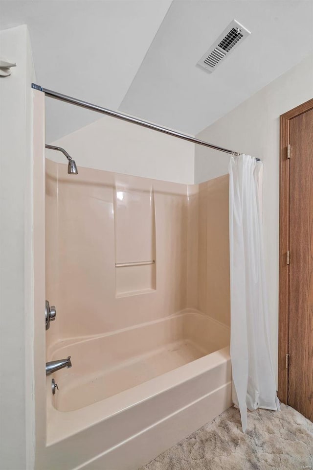 bathroom featuring visible vents and shower / bathtub combination with curtain