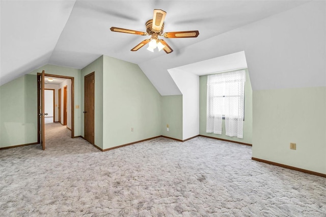 bonus room featuring ceiling fan, light colored carpet, and baseboards