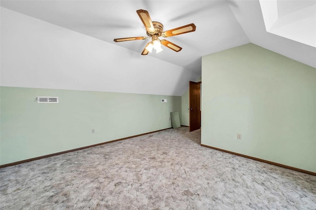 additional living space with lofted ceiling, ceiling fan, carpet floors, visible vents, and baseboards