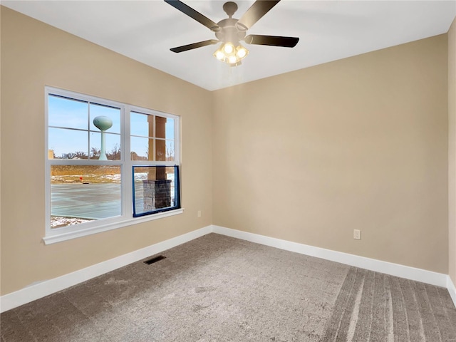 carpeted empty room featuring ceiling fan and a wealth of natural light