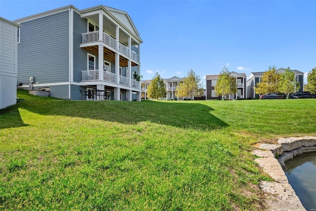 view of yard with a balcony