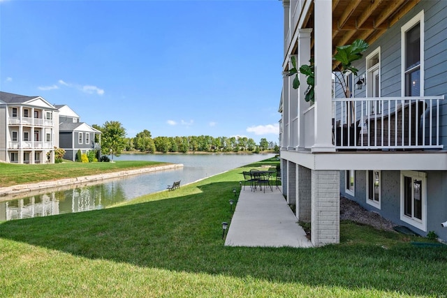 view of yard with a water view and a patio