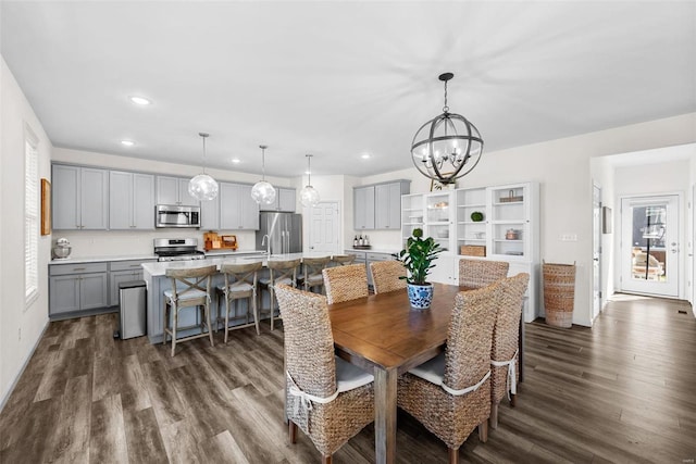 dining space featuring an inviting chandelier, dark wood-style floors, and recessed lighting