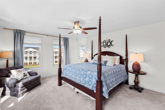 bedroom featuring baseboards, light carpet, and multiple windows