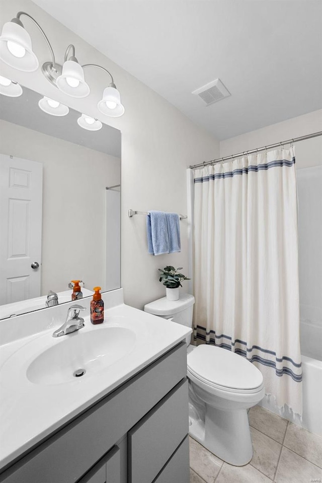 full bathroom featuring vanity, visible vents, tile patterned flooring, toilet, and shower / bath combo