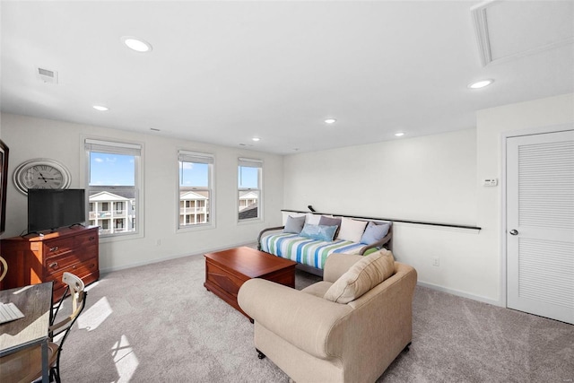 living room featuring visible vents, light colored carpet, a healthy amount of sunlight, and recessed lighting