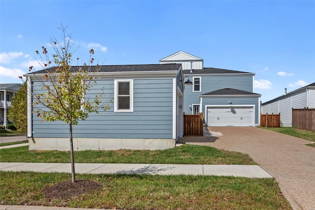 view of front of home featuring fence and driveway