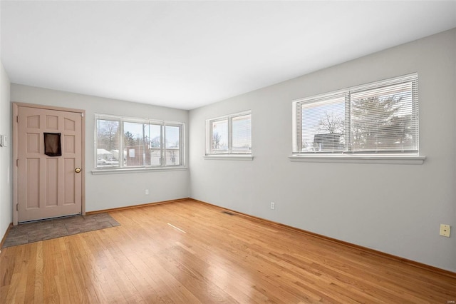 foyer with light wood-style floors and visible vents