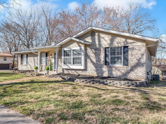 ranch-style house with brick siding, central AC unit, and a front yard