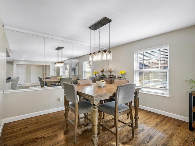 dining area featuring baseboards and wood finished floors