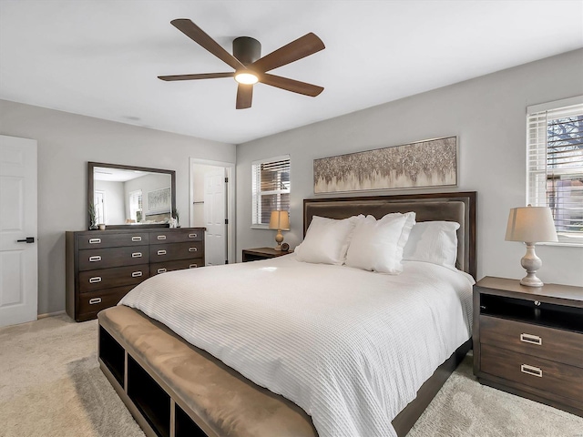 bedroom with light carpet and a ceiling fan