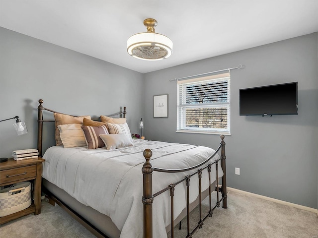 bedroom with carpet and baseboards